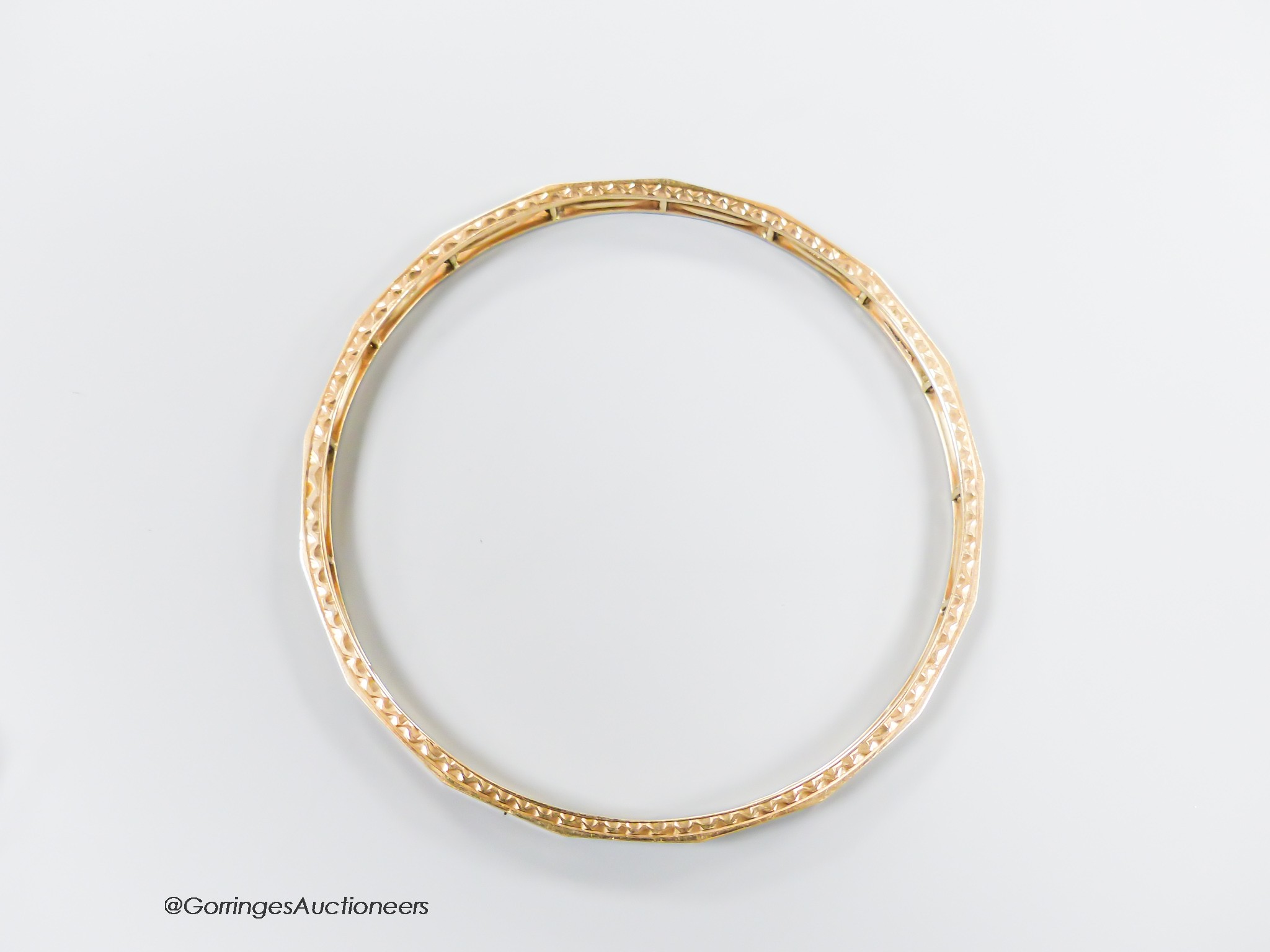 A pierced 9ct bangle, interior diameter 68mm, 13.2 grams.